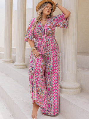 Bohemian tie-front palazzo jumpsuit in deep rose with bell sleeves and a vibrant paisley print.