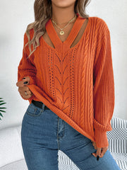 Terracotta cable knit sweater with cutout neckline and open knit details.