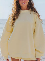 Yellow crew neck sweatshirt with relaxed fit and ribbed cuffs and hem.