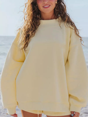 Yellow crew neck sweatshirt with relaxed fit and ribbed cuffs and hem.