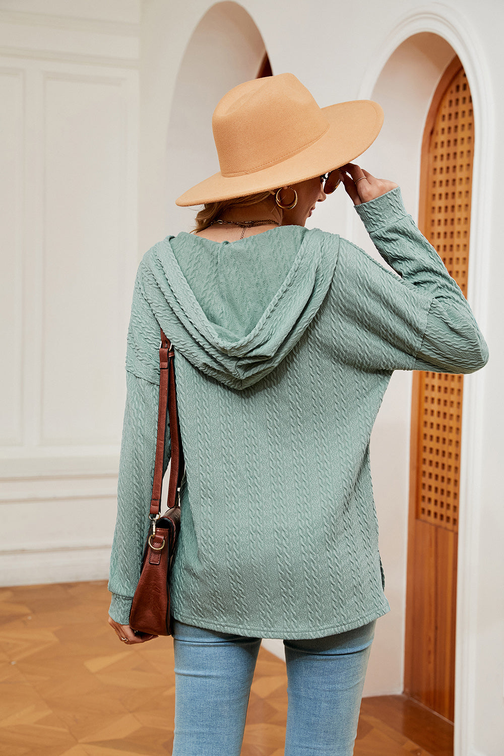 Green textured henley hoodie with drop shoulder and cable knit pattern.