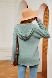 Green textured henley hoodie with drop shoulder and cable knit pattern.