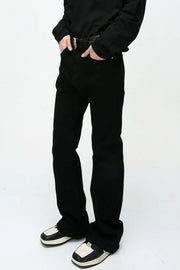 Flared leg black denim jeans with a casual 70s style.