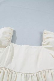 Cream puff sleeve dress with square neckline and ruffled hem detail.