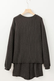 Dark gray ribbed lounge set with a graphic baseball detail, crew neck, and long sleeves.