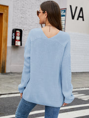 Sky blue ribbed knit sweater with V-neck and lace-up detail on sleeves.