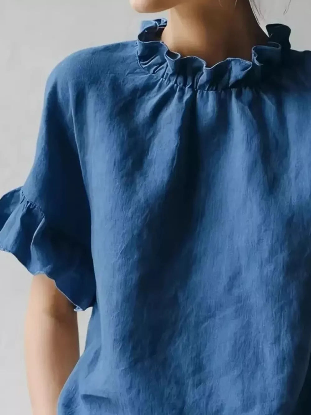 Dark blue half-sleeve shirt with ruffled neckline and flutter sleeves