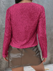 Hot Pink sequin bolero jacket with long sleeves and puffed shoulders.