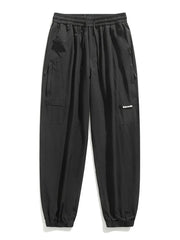 Black jogger sweatpants with drawstring, elastic cuffs, and cargo pockets.