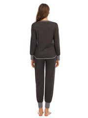 Charcoal loungewear set with striped trim on neckline, cuffs, and ankles.