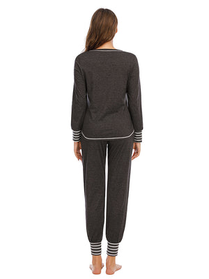 Charcoal loungewear set with striped trim on neckline, cuffs, and ankles.