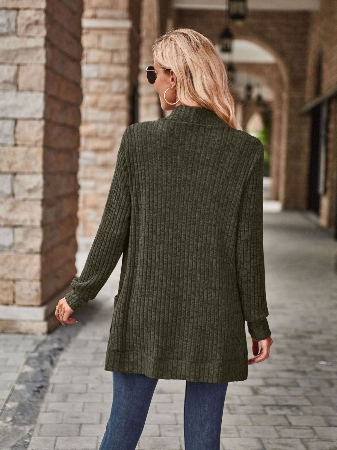 Dark green ribbed open-front cardigan with long sleeves and pockets.