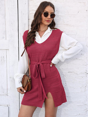 Deep Red knit vest dress with V-neck, tie waist, and slit, layered over a white shirt.