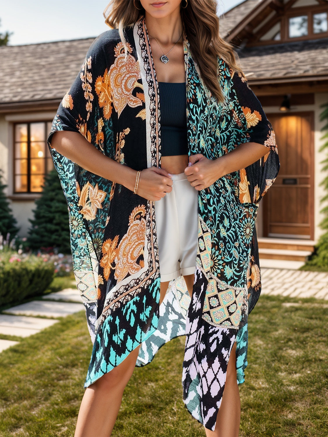 Bohemian patchwork print kimono with black and light blue floral patterns, open front, and wide sleeves.