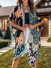 Bohemian patchwork print kimono with black and light blue floral patterns, open front, and wide sleeves.