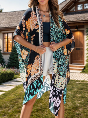 Bohemian patchwork print kimono with black and light blue floral patterns, open front, and wide sleeves.