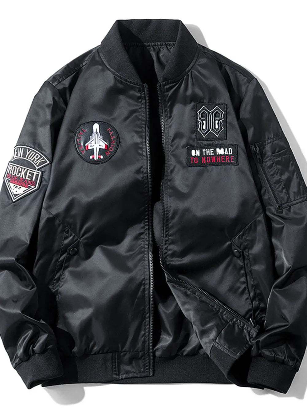 Black bomber jacket with embroidered patches including a jet and text.