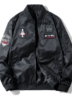 Black bomber jacket with embroidered patches including a jet and text.