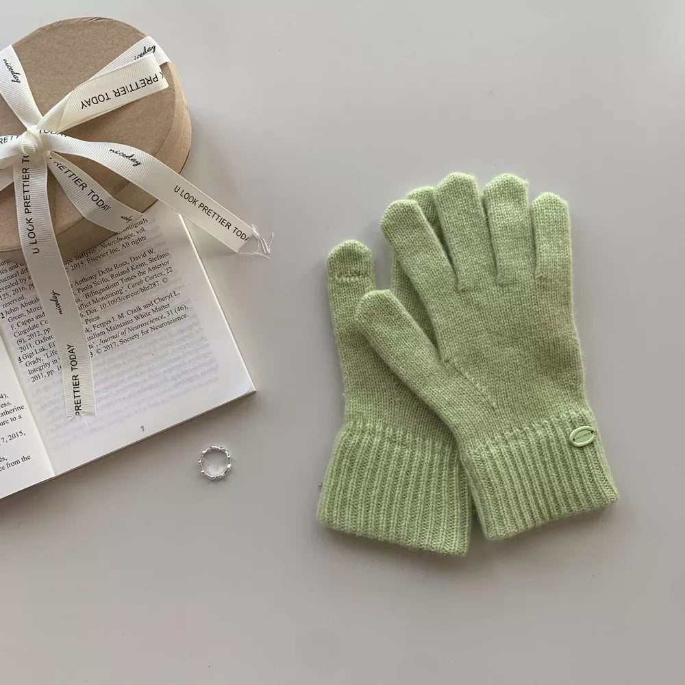 Luxurious wool knit gloves in Matcha Green with ribbed cuffs and decorative button detail.
