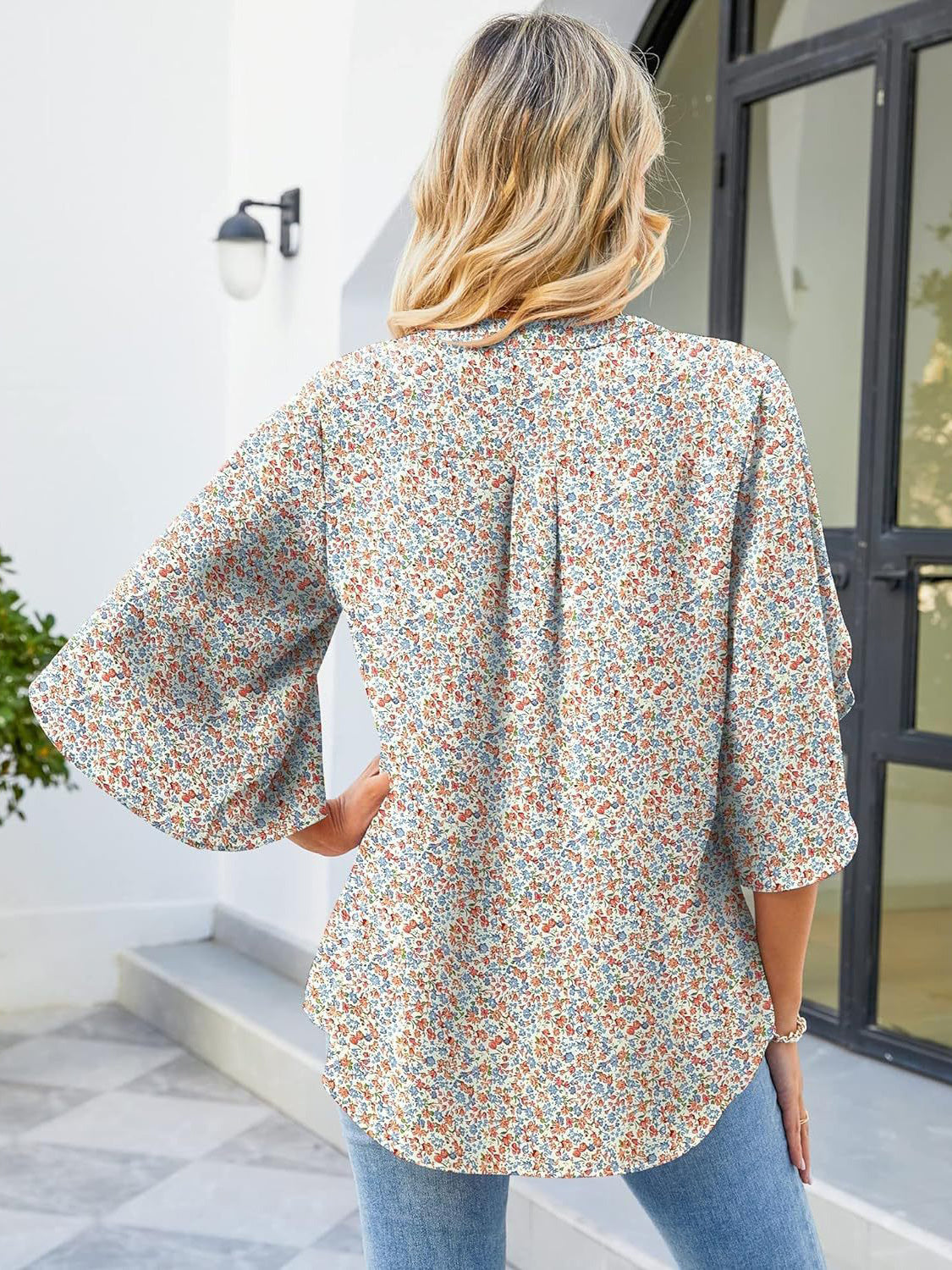 Flutter sleeve floral blouse with V-neck and relaxed fit, made of 100% polyester.