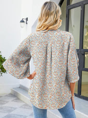 Flutter sleeve floral blouse with V-neck and relaxed fit, made of 100% polyester.