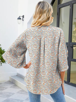 Flutter sleeve floral blouse with V-neck and relaxed fit, made of 100% polyester.