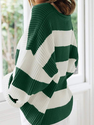 Striped oversized knit sweater in dark green and white with a crew neck.