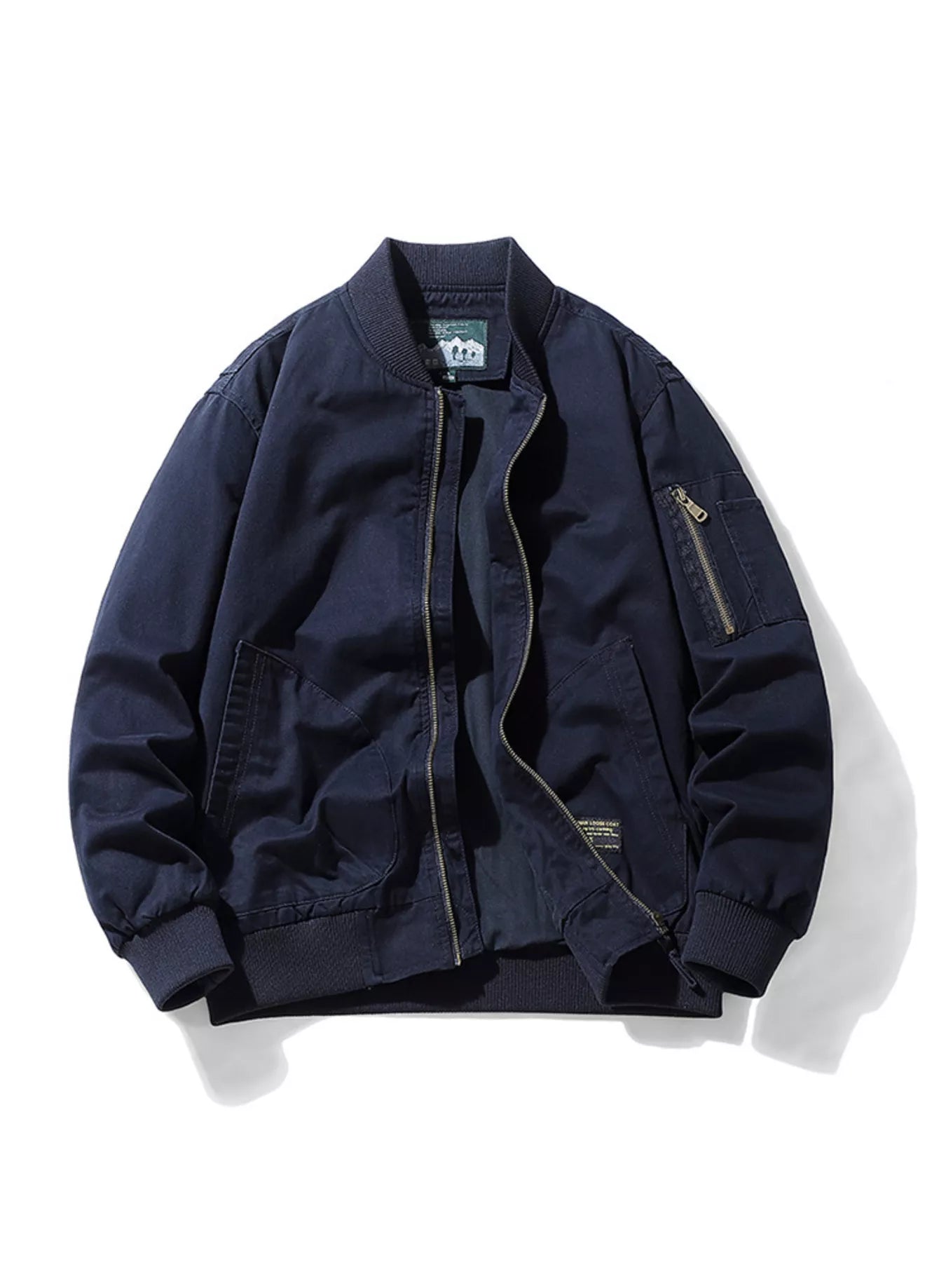 Plus-size navy blue cotton bomber jacket with zip-up front and zippered sleeve pocket.
