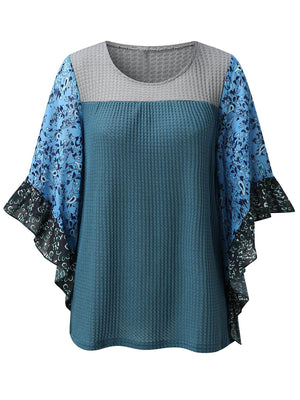 Textured panel blouse in Dusty Blue with gray and floral print flutter sleeves.