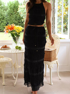 Black halter neck smocked crop top and tiered maxi skirt set with beaded trim