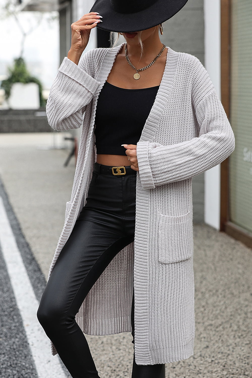 Light gray longline knit cardigan with pockets and cuffed sleeves.