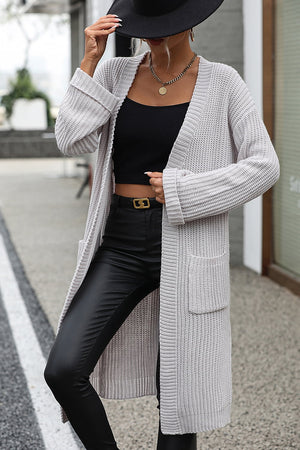 Light gray longline knit cardigan with pockets and cuffed sleeves.