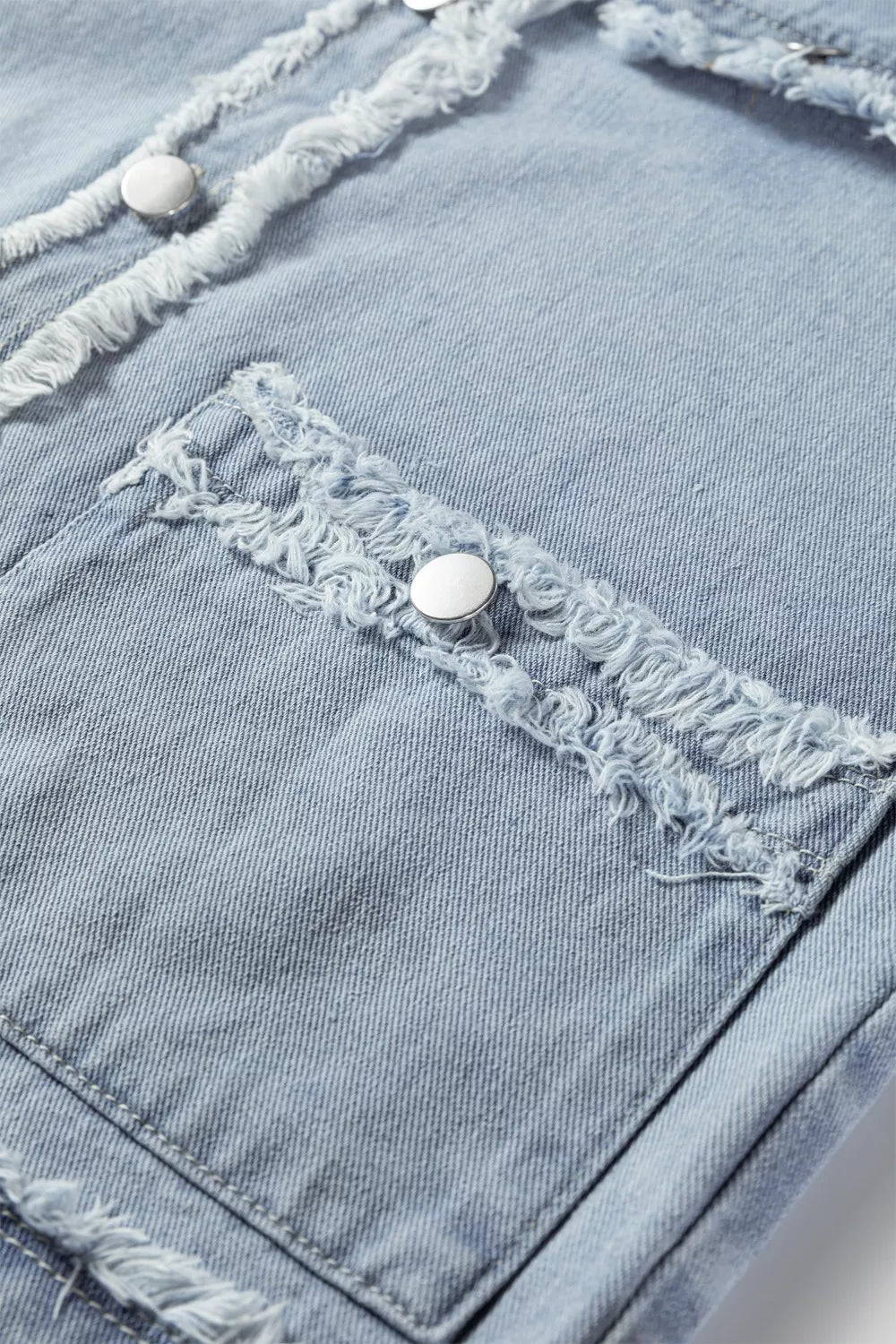 Light wash denim vest with frayed edges, button front, and chest pockets.
