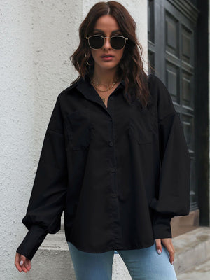 Black oversized poplin blouse with blouson sleeves and two chest pockets.