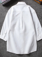 White button-up undershirt with 3/4 sleeves and buttoned cuffs.