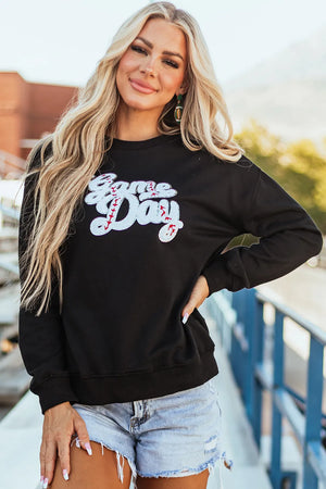 Black sweatshirt with white sequin baseball script applique that reads Game Day.