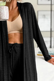 Black duster cardigan and joggers set with drawstring waist, worn with a beige bra.