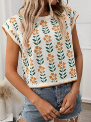 Floral knit sleeveless top in cream with orange flowers and green leaves pattern.