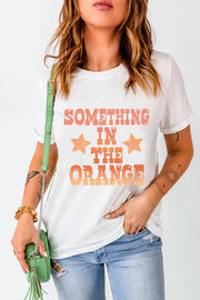 White graphic tee with faded orange text and stars, casual crew neck t-shirt.