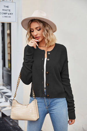 Black textured knit cropped cardigan with button front and crew neck.