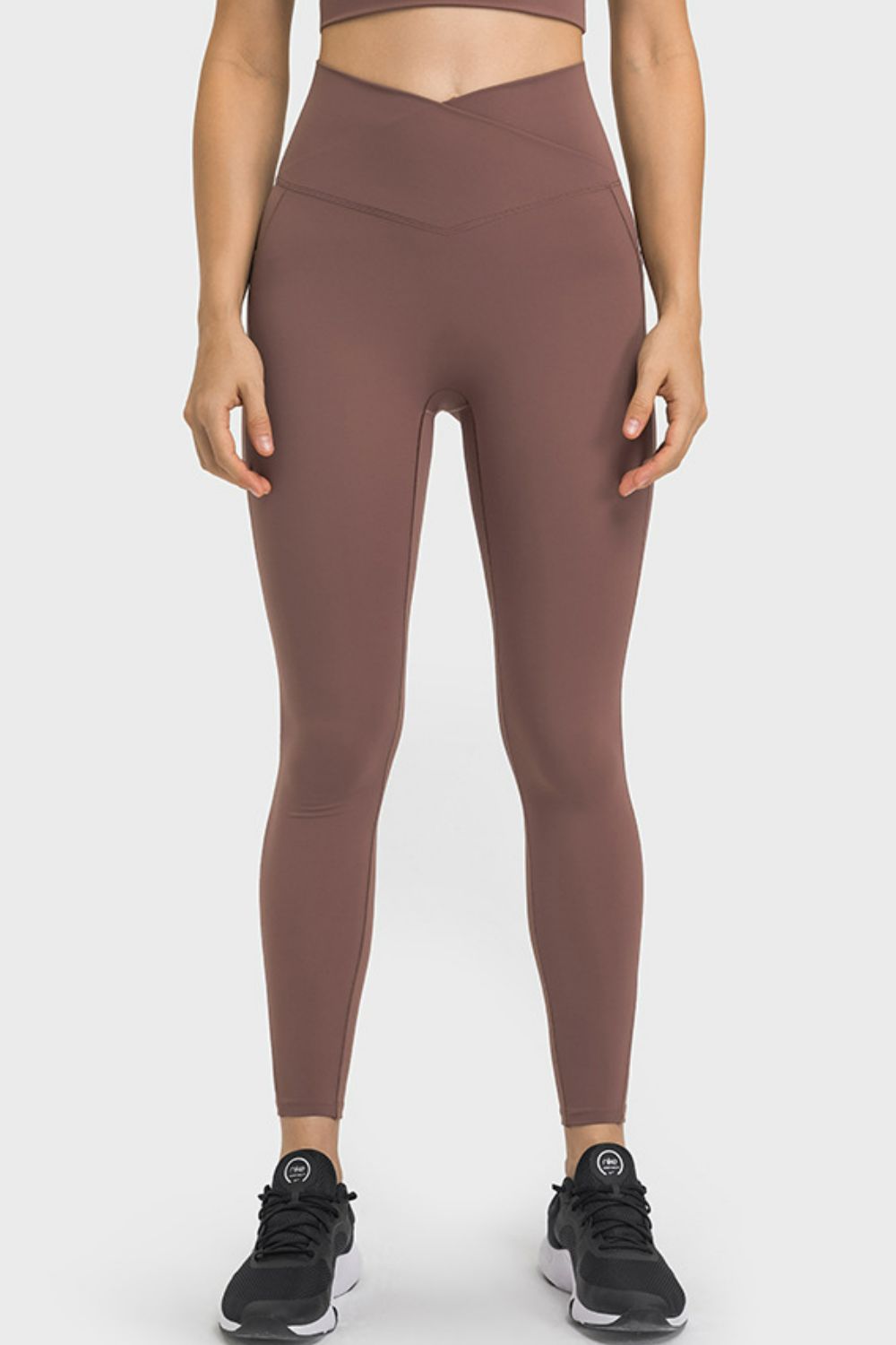 Brown performance leggings with sculpted waistband and pockets
