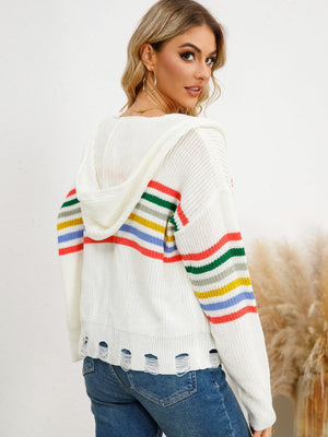 White distressed knit hoodie with rainbow stripes on sleeves and hem.