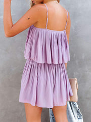 Lilac cami romper with delicate straps and tiered pleated design.