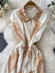 White button-down romper with brown paisley print, collared neckline, and elastic waist.