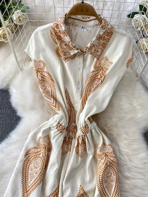 White button-down romper with brown paisley print, collared neckline, and elastic waist.