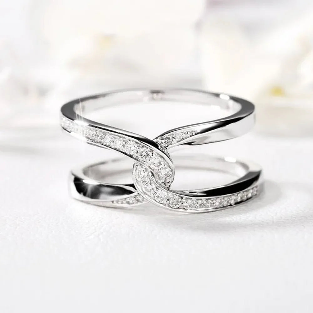 Silver intertwined pavé band ring with cubic zirconia accents