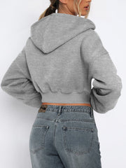 Gray cropped zip-up hoodie with ribbed hem and balloon sleeves.