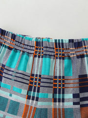 Toddler shorts with elastic waistband and blue, teal, orange plaid pattern.