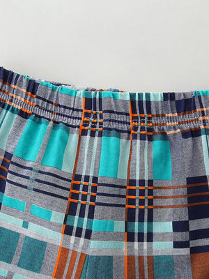 Toddler shorts with elastic waistband and blue, teal, orange plaid pattern.