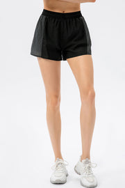 Black colorblock performance running shorts with elastic waistband.